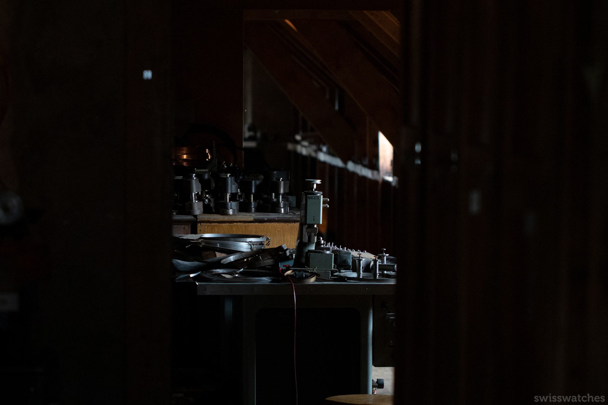 A dark room with watch machinery hidden in Charles Vermot Zenith manufacture