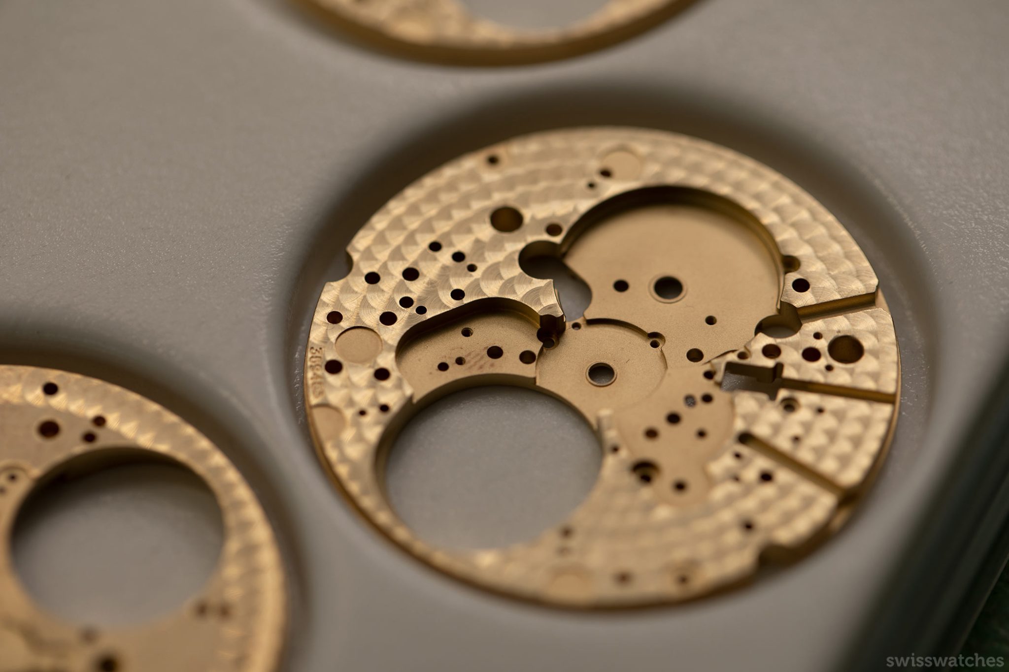 The base of a dial decoration with perlage