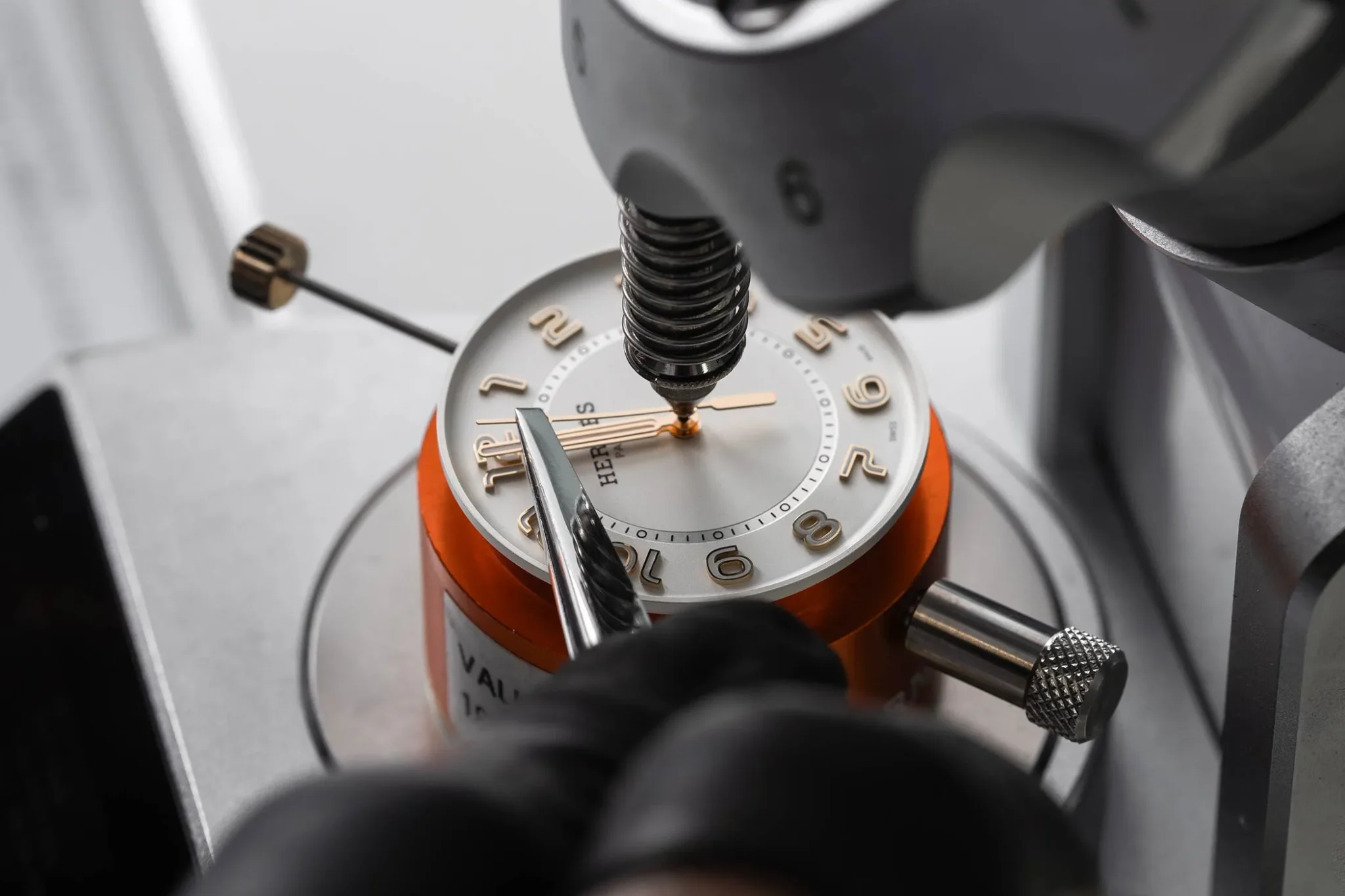 Assembling a Hermès H08 watch, showcasing expert craftsmanship and attention to detail in creating a sophisticated timepiece with a modern design and Swiss precision