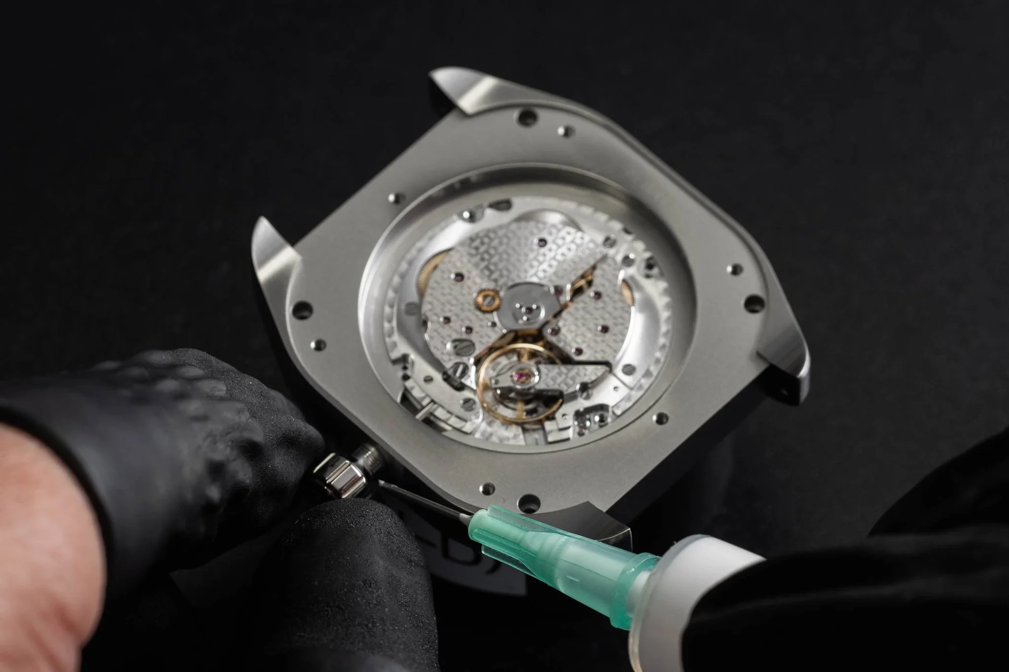 Assembling a Hermès H08 watch, showcasing expert craftsmanship and attention to detail in creating a sophisticated timepiece with a modern design and Swiss precision