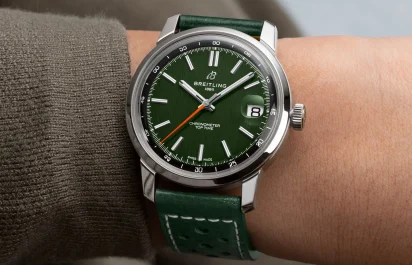 Wristshot of the Breitling Top Time B31 with a green dial and green leather strap.