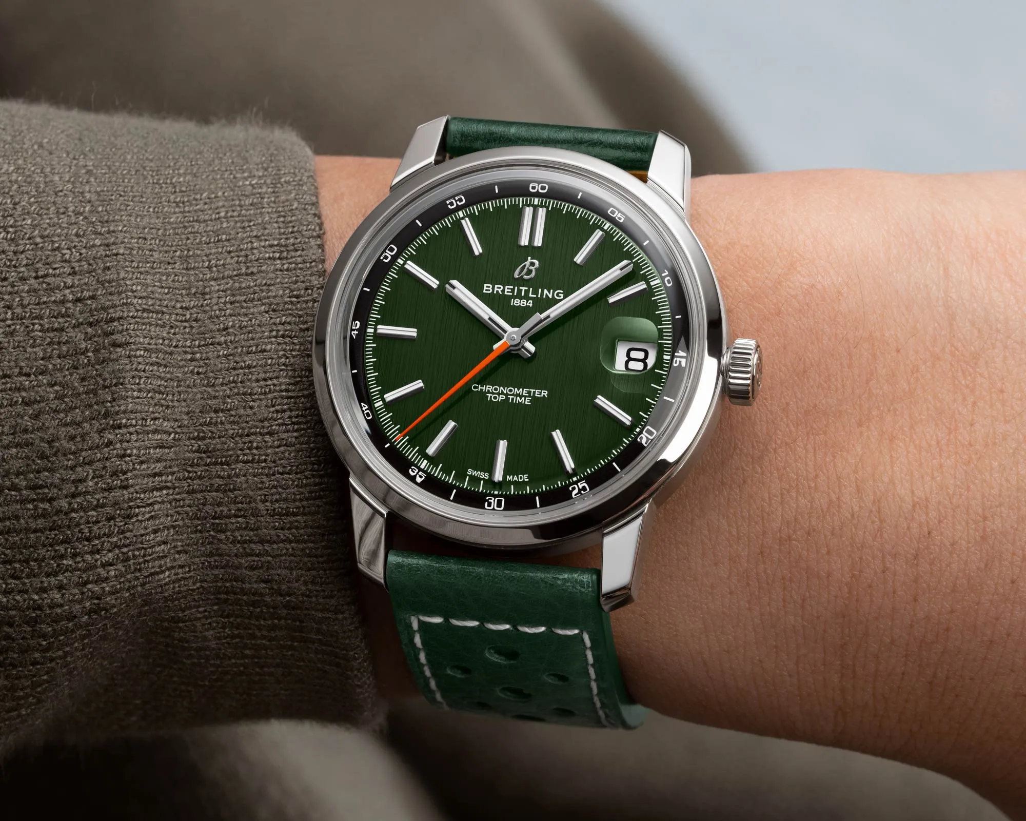 Wristshot of the Breitling Top Time B31 with a green dial and green leather strap.