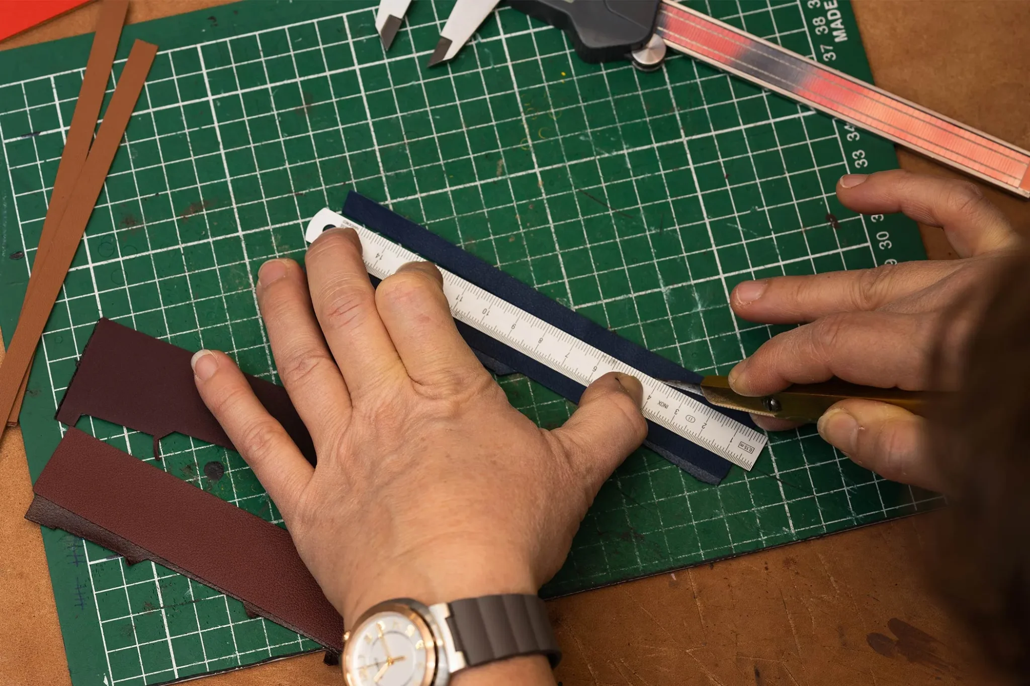 Hermès Watch Manufacture assembling the luxurious leather strap, showcasing expert craftsmanship and attention to detail in creating a high-quality, elegant timepiece