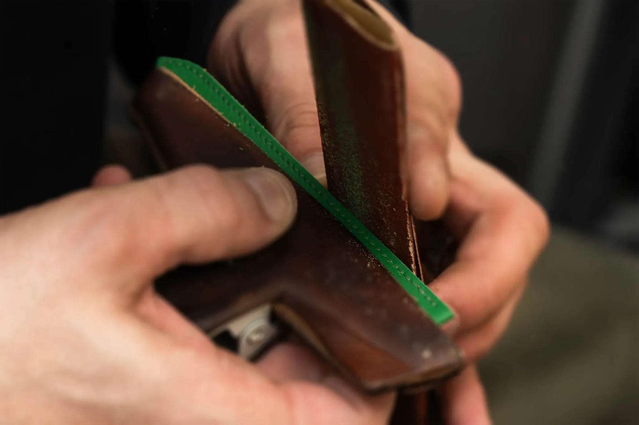 Polishing a Hermès watch strap by hand, highlighting luxury leather craftsmanship and precision finishing techniques
