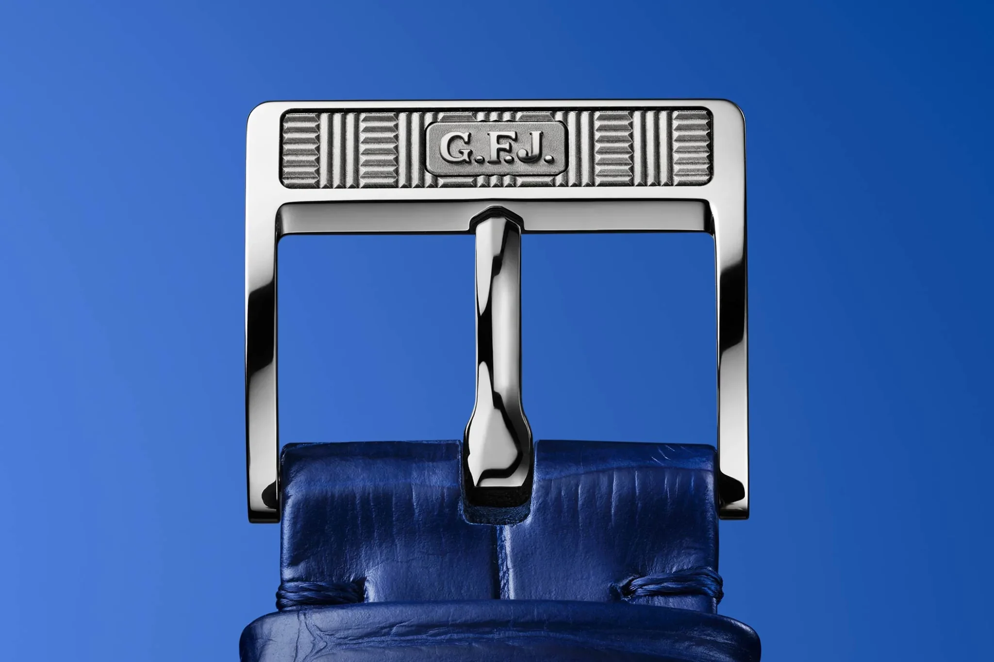 Close-up of the dark blue alligator leather strap’s platinum pin buckle