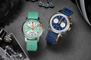 The limited-edition Breitling Top Time B01 Gino Bartali in blue and the Breitling Top Time B01 Fausto Coppi next to each other, surrounded by historic images and bike utensils.