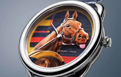 The Hermès Arceau Rocabar de Rire in front of a grey background.