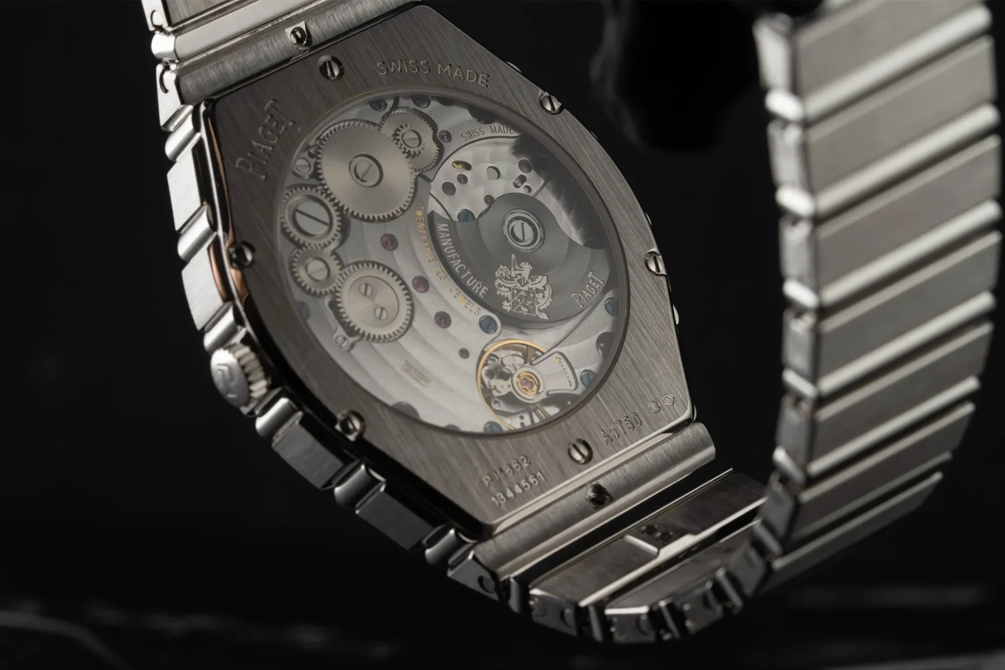 Close up of the Piaget Polo 79, made of white gold and showcasing the mechanical movement through an open caseback.