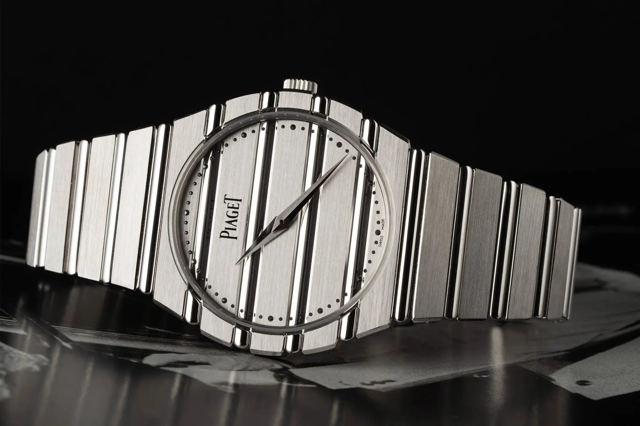 The Piaget Polo 79 white gold lies on its side, displaying its distinctive line design.