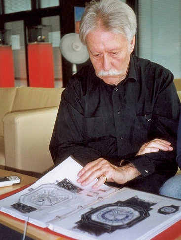 Gérald Genta checking his Gerald Charles watch designs, showcasing his creative process and legacy in Swiss watchmaking.