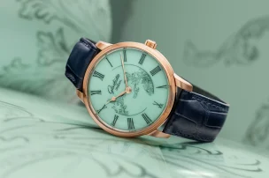 The Glashütte Original Senator Meissen with Mystic Maison in celadon green against a celadon green background.