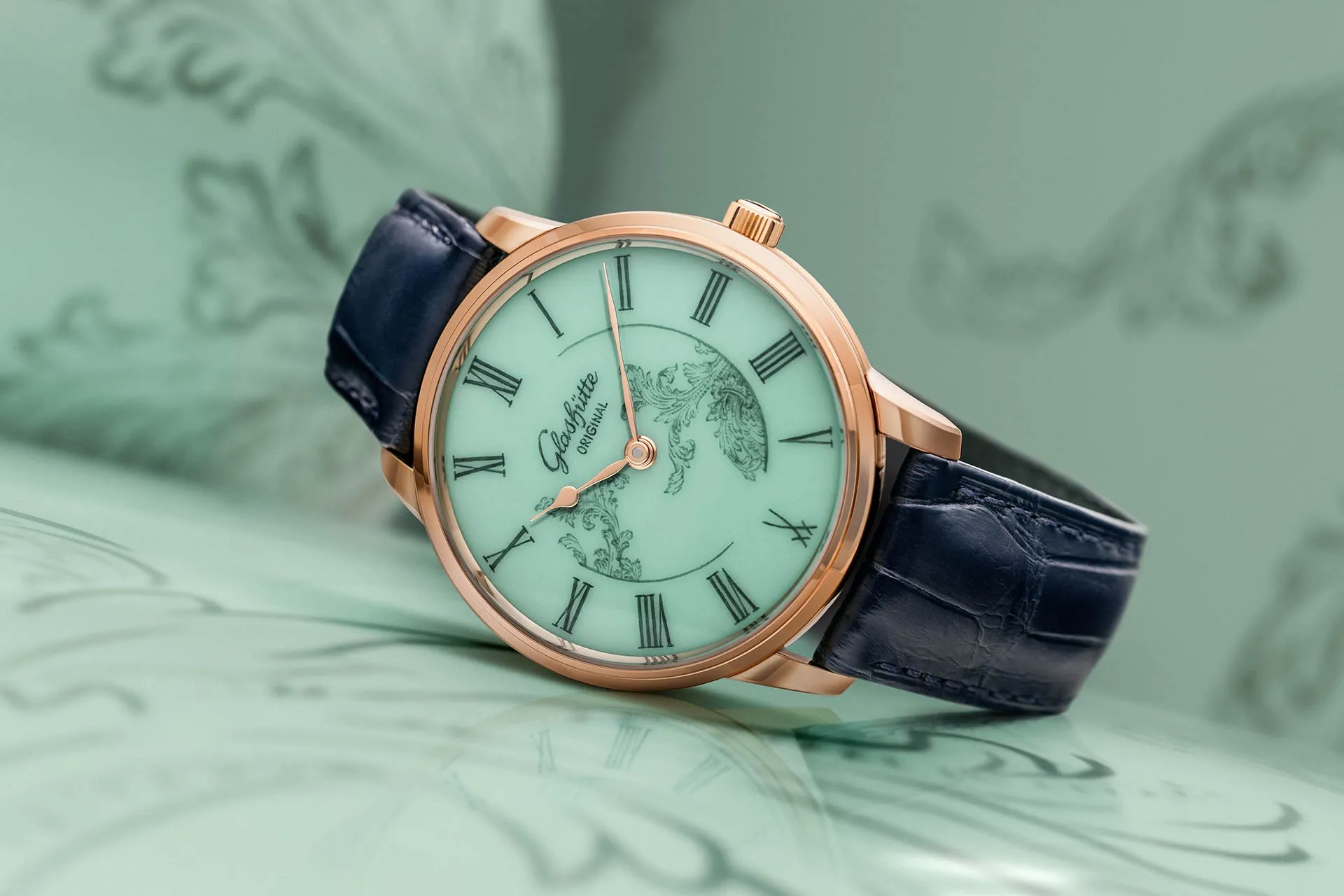 The Glashütte Original Senator Meissen with Mystic Maison in celadon green against a celadon green background.