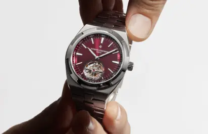 Two hands hold the Overseas Tourbillon in titanium by Vacheron Constantin