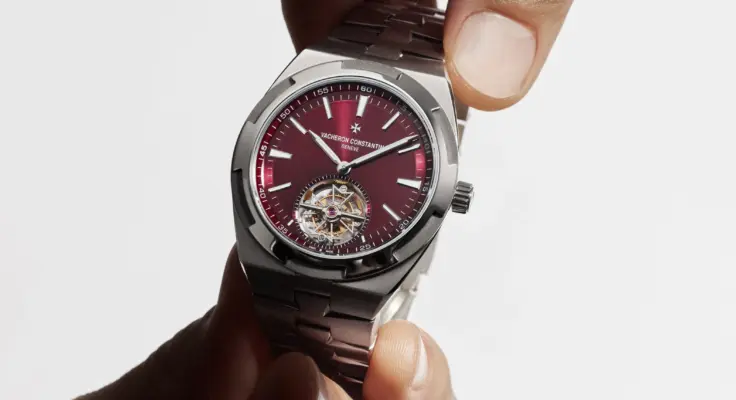 Two hands hold the Overseas Tourbillon in titanium by Vacheron Constantin