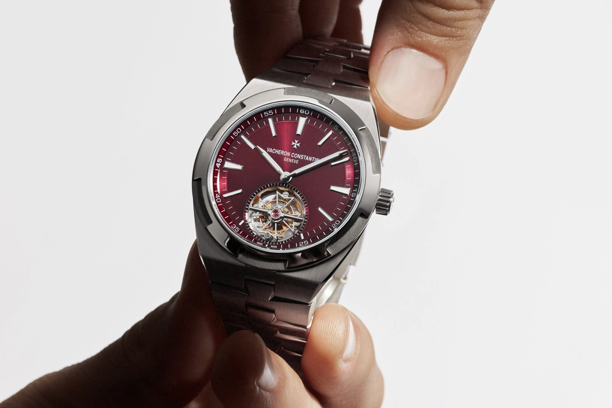 Two hands hold the Overseas Tourbillon in titanium by Vacheron Constantin