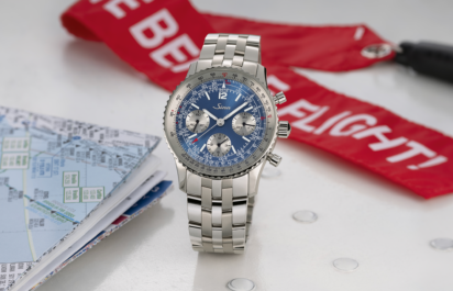 The Sinn 903 Ti II Jubiläum chronograph with blue dial, silver subdials, tachymeter and slide-rule scales, shown from the front on a multi-link stainless steel bracelet.