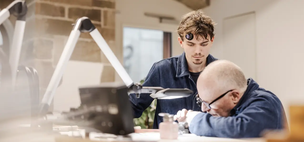 The watchmaking instructor Jean-Marc Figols with an apprentice