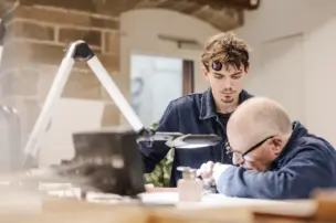 The watchmaking instructor Jean-Marc Figols with an apprentice