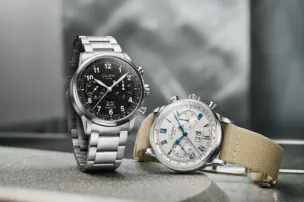 A Glashütte Original Senator Chronograph with a fabric strap and a version with a metal strap are on display together.