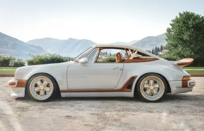 A Singer x Louis Vuitton Porsche 911 Classic Turbo Cabriolet is seen from the side.