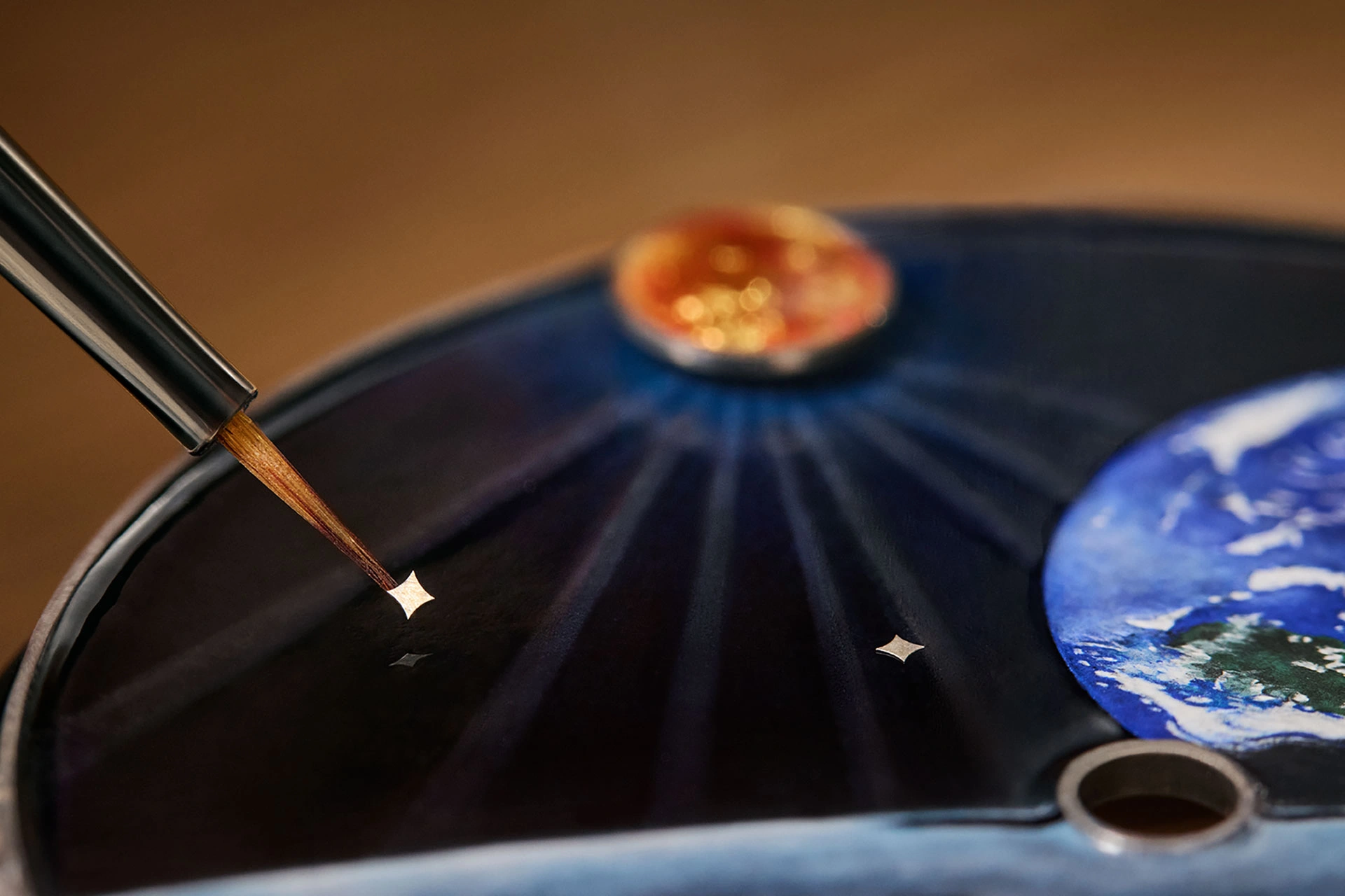 Enamel work on the dial of the Tambour Automata Taiko Galactique, finely crafted by hand