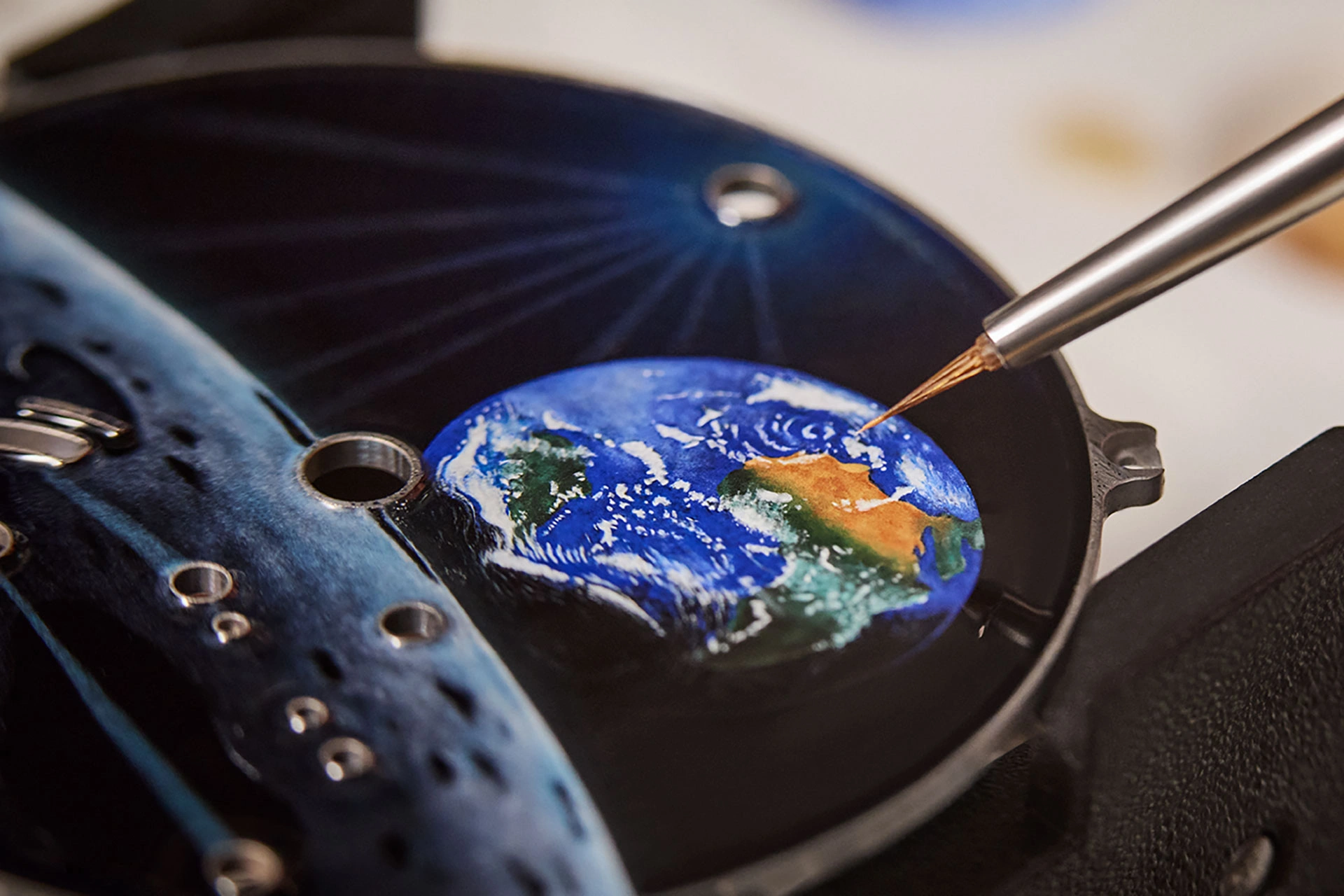 Enamel work on the dial of the Tambour Automata Taiko Galactique, finely crafted by hand