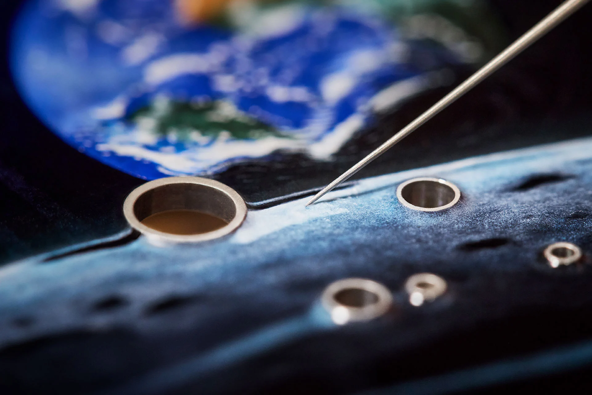 Enamel work on the dial of the Tambour Automata Taiko Galactique, finely crafted by hand
