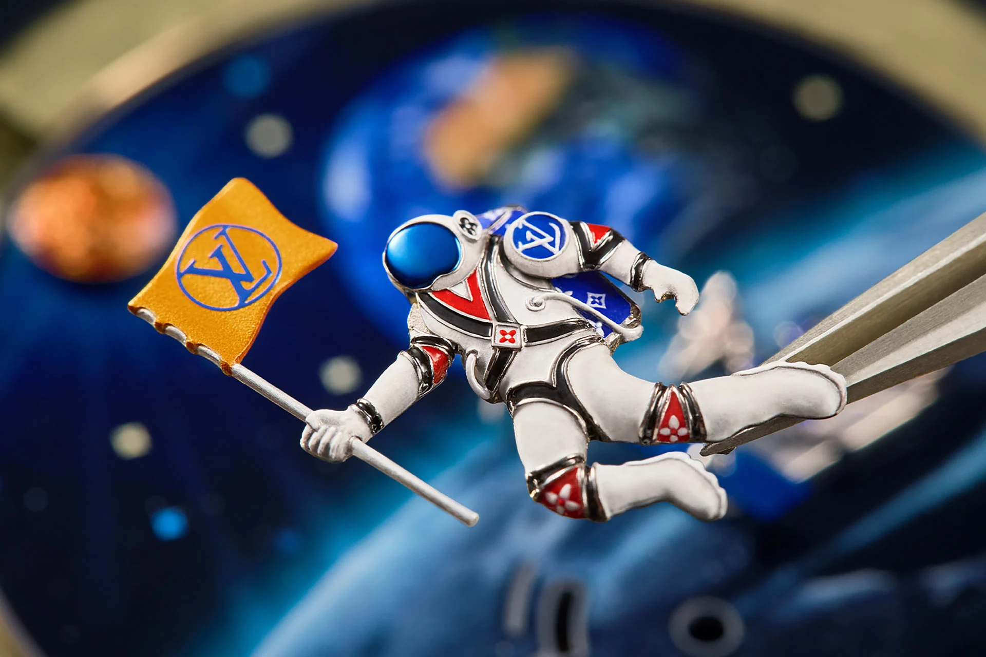 Hand engraved astronaut figure on the dial of the Tambour Automata Taiko Galactique